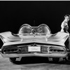 The Lincoln Futura -- called the most revolutionary and advanced vehicle ever to be driven on public highways -- all but stopped Manhattan traffic when it was given its driving premier in New York City. This full rear view shows the Futura's 'shark-fin' rear fenders which house the tail lights and its circular radio aerial, combined with an 'audio approach' microphone designed to pick up and amplify the sound or horn signal from any car approaching from behind.