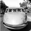 Four men driving down street in Davis Motorcar three-wheeled car, Los Angeles, CA, US. (1947). Photographer: Allan Grant