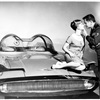 Debbie Reynolds and Glenn Ford posing with a 1955 Lincoln Futura car. This experimental car was featured in the 1959 film, "It started with a kiss."