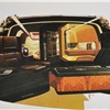 Conversation format - When our land yacht is parked, its brain box (front center) can be closed and pivoted to double as a cocktail table. The bath is shown with its door cut away; to its left are the food-prep unit and audio-video center. At rear, you see the open-air skylight with its electronic sun deck partially lowered.