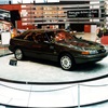 Based on the production Mustang, a four-wheel-drive Ghia Vignale concept car sits on a raised round platform at Ford's main-floor display space (1985 Chicago Auto Show)
