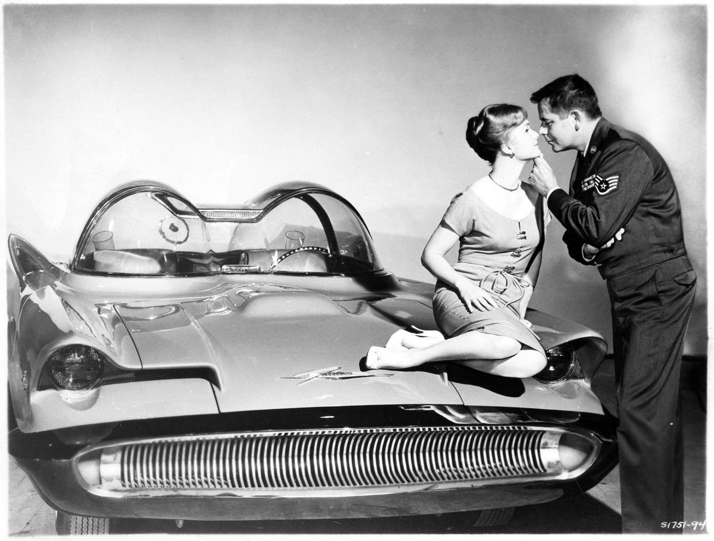 Debbie Reynolds and Glenn Ford posing with a 1955 Lincoln Futura car. This experimental car was featured in the 1959 film, "It started with a kiss."