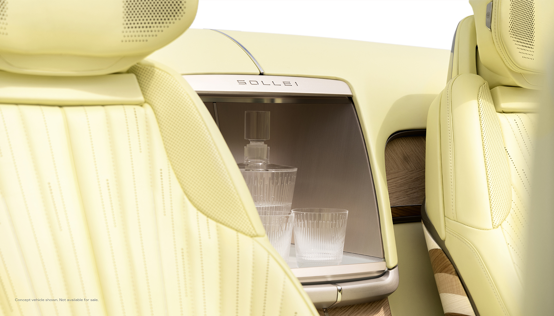 Interior view of Cadillac SOLLEI concept vehicle with Sunburst Motif pattern seats and crystal glass accessory inside integrated beverage chiller